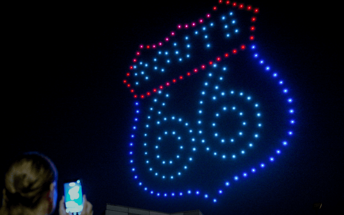 Drone formation of a Route 66 shield in red, white, and blue at night