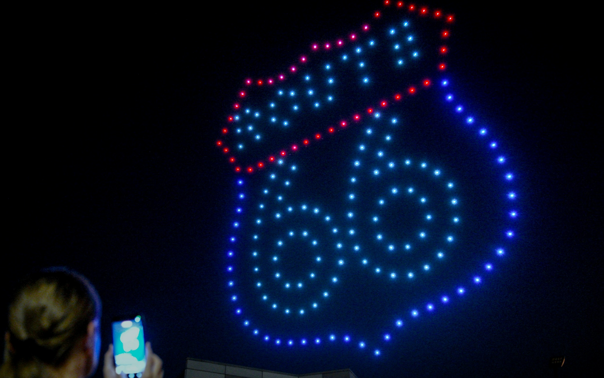 Drone formation of a Route 66 shield in red, white, and blue at night